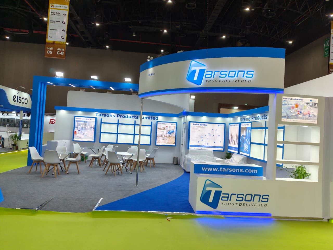Tarsons stall — curved illuminated fascia carrying the Tarsons logo above the lounge seating
