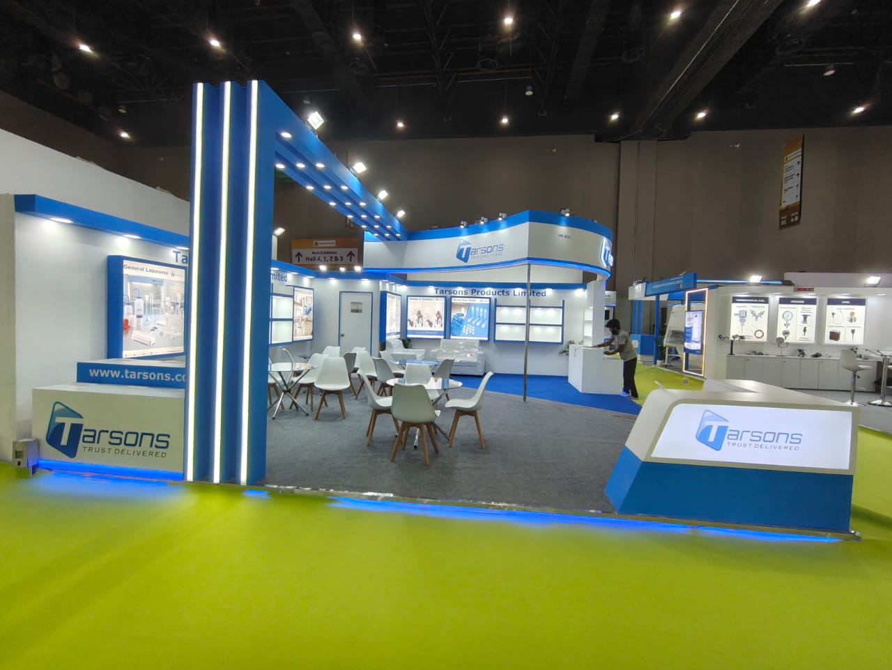 Tarsons stall interior — product display walls, meeting tables and lounge seating